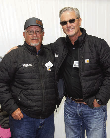 Mid-Plains General Manager Dusty George (right) congratulates Chris Wright on 34 years of service with Mid-Plains Communications