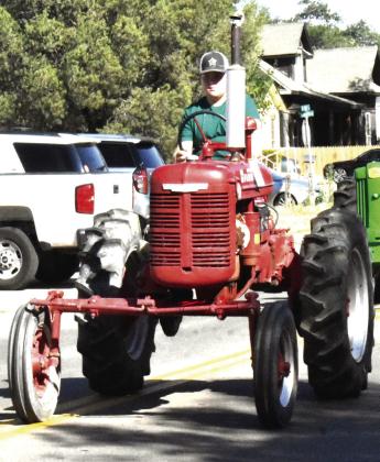 MOST EXPERIENCED PLOWHORSE--Slade Schlabs/ Cayden Schlabs/Ray Schlabs, exhibited the Oldest Tractor, a 1940 Farmall A. (Photo by Jim Steiert)