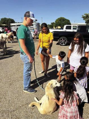 DOGGONE NICE--Kids and adults of all ages appreciate and respond to a friendly, well-trained and controlled dog and its responsible owner/handler. Dogs running loose minus responsible owners are an ongoing problem in Hereford that is causing concern among city residents and officials. (Photo by Jim Steiert)