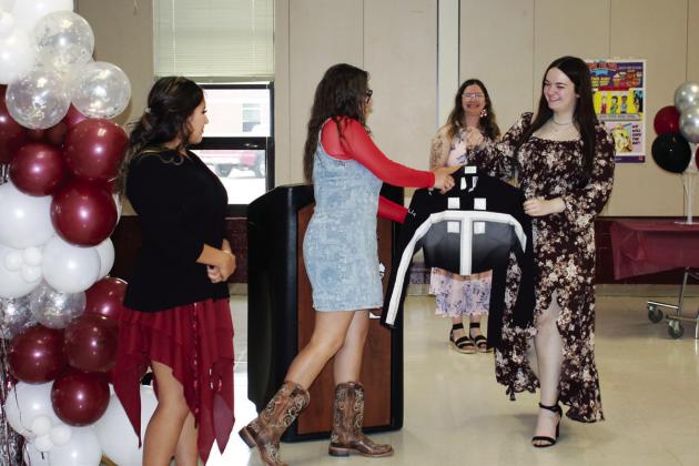 Drum Major Avary Wesley passed on the Drum Major jacket to Ava Comans and Selestina Hernandez