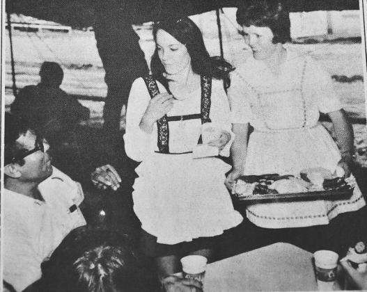 APPETIZERS BEFORE THE FEAST--Clad in classic German folk attire lovely Nazareth ladies carry trays of appetizers for folks wait - ing to enter the Nazareth Community Hall for the big German Festival dinner in Nazareth in this photo from an August 1974 issue of the Castro County News. The Festival was held on Sun - days in its initial years.