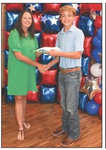 Christina Flowers presented Hudson Butler with a Project pin