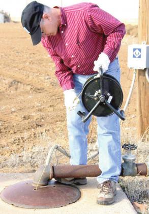 Field Staff Supervisor Keith Whitworth uses an E-Line to make a water level measurement in an observation well. (photo courtesy of HPWD)