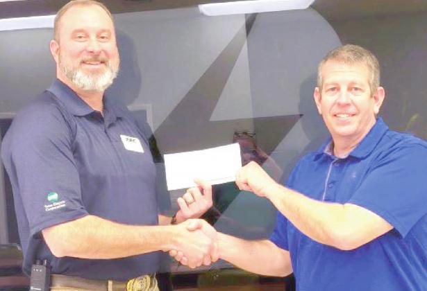 Deaf Smith ED Tim Burkhalter, president and general manager presented a donation to Chris Woodard, Hereford Volunteer Fire Department treasurer.
