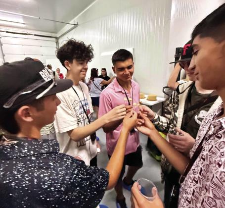 BE A LAMB, HAVE SOME CHEESE--Max Hedrick joins fellow Texas 4-Hers in tasting a sample of cheese made from ewe milk. The Texas visitors found little beef on the menu-even burgers were made with pork patties, but they did sample a gourmet version of Iberian jamones, the leg of ham from Iberian pigs.
