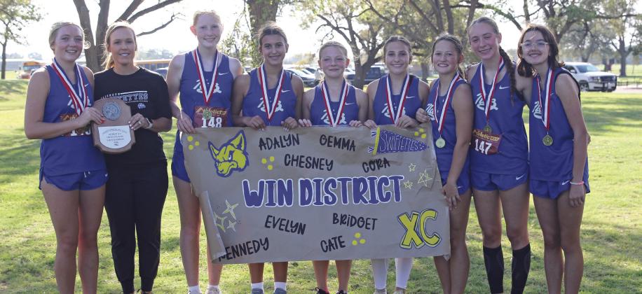 Bridget Osterkamp, Coach Whitney Bryan, Kennedy Wilhelm, Cate Moore, Adalyn O’Connor, Chesney Farris, Gemma Pohlmeier, Cora Rogers and Evelyn Farris pictured with the district championship trophy