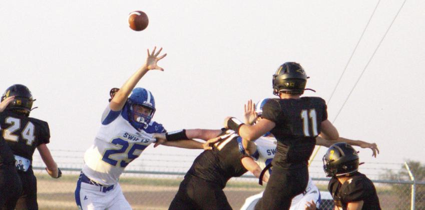 Only attempt - Happy Cowboy Luke Dempsey (#11) kicks the ball as Nazareth Swift Quincy Hartman (#25) attempts to block the lone extra point kick by the Cowboys. The Swifts won the matchup 52-6 on August 28th in Happy.