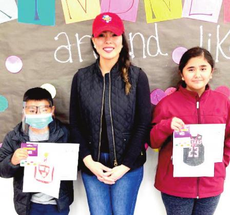 Richardson Elementary School Principal Maritssa Flores congratulated the students who won the College Week coloring contest, Kaiden Phan, 4th grade, and Liliana Rivera, 5th grade.