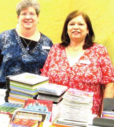 Rhoads Memorial Library Director Gaye Reily, left, and Assistant Director Sulema Oltivero sort through 237 new books and 40 DVDs purchased via two grants totaling $3,750 for the Juvenile section. The items arrive in time for the Summer Reading program that starts on June 1.