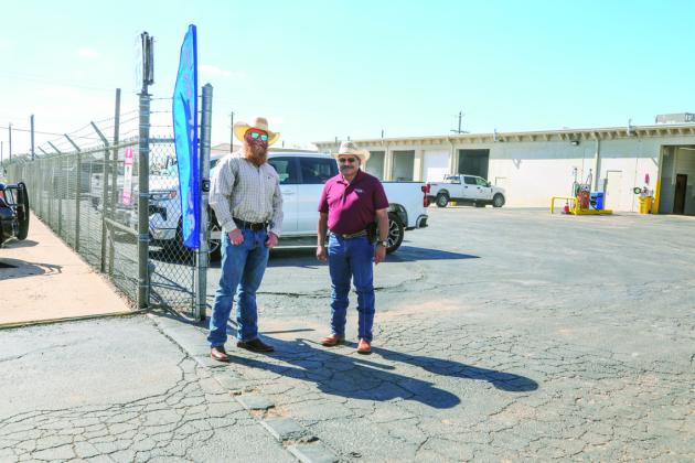 Welcome committee at the Swisher Electric Annual Cooperative Month Hamburger cook-out, Corey Morton and Henry Cruz