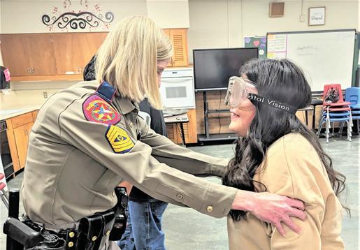 Family Consumer Science/Health classes at Dimmitt Middle School experienced DWI goggles while trying to walk a straight line, Aliyah Castillo needed a little help from DPS Sergeant Barkley.