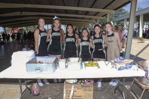 Happy High School Cheerleaders served BBQ meals at the Picnic lunch