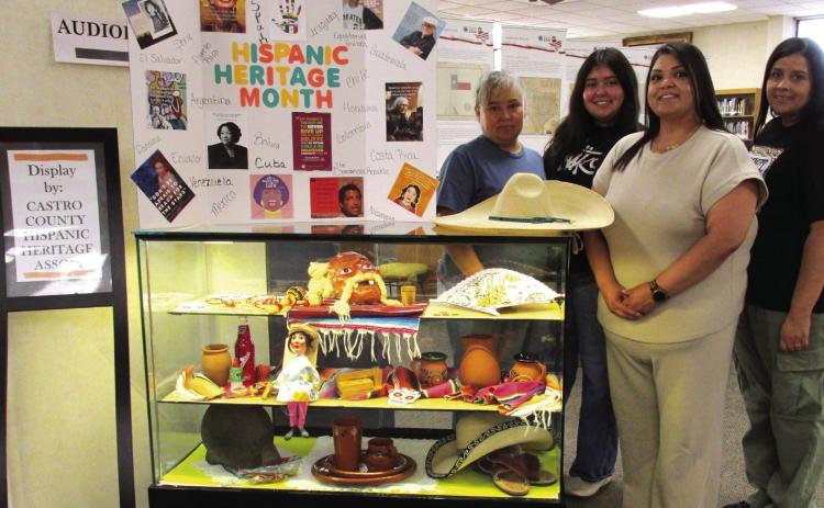 Display for the months of September and October, 2026, at Rhoads Memorial Library features items pertaining to Hispanic Heritage Month. Exhibiting some of their cultural items are, from left, Ofelia Lopez, Maria Lopez, Priscilla Peralta, and Laura Carrasco.