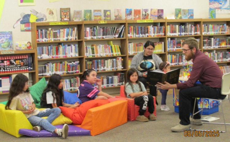 The Summer Reading Program has come to an end at Rhoads Memorial Library. One of the volunteers making it a success was Mavrik Gfeller, who read to youngsters during Story Time.