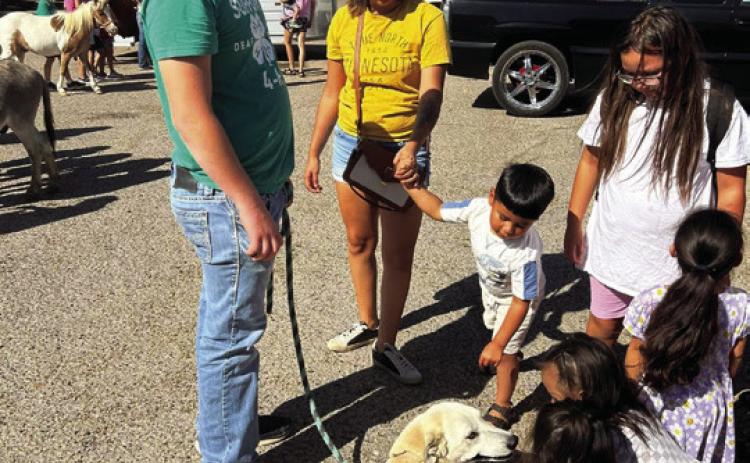 DOGGONE NICE--Kids and adults of all ages appreciate and respond to a friendly, well-trained and controlled dog and its responsible owner/handler. Dogs running loose minus responsible owners are an ongoing problem in Hereford that is causing concern among city residents and officials. (Photo by Jim Steiert)
