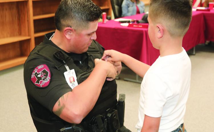 Officer Mendez’s son pins on his badge