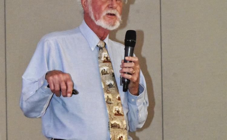 DIRT DIGGER--Joe D. Rogers, Registered Professional Archaeologist and well-remembered former teacher of History at Hereford High School, spins tales of dig adventures to members of the Texas Association of Healthcare Volunteers during their district meeting in Hereford on September 18 at the Hereford Civic Center. (Photo by Jim Steiert)