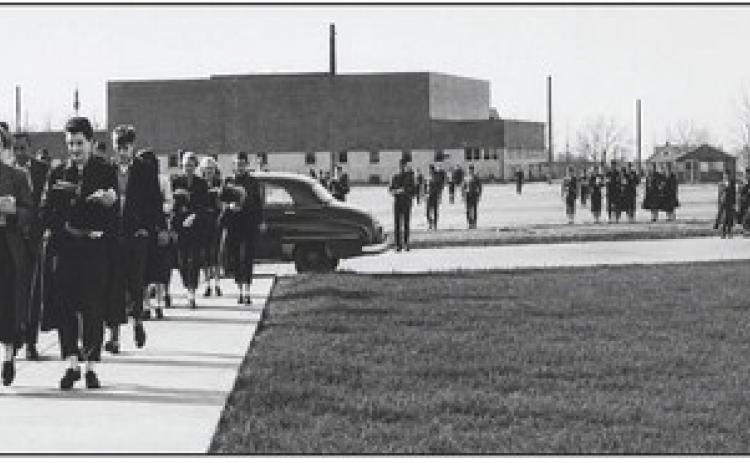 HIGH SCHOOL MIGRATION—This photo from December of 1954 shows Hereford students moving their things to the new digs of Hereford High School from what had previously been HHS and was to become Stanton Junior High. Note the classic car, and the apparel of the students, a scene right out of “Back to the Future.”