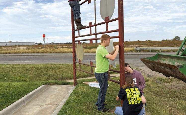 PAINTING ONE DAY--During the Happy One Day 4-H observance on Saturday, October 11, Deaf Smith County 4-Hers worked to make the best better by putting a new coat of paint on the Welcome to Hereford sign on the north side of Hereford. Laying on new paint are 4-Hers Johan and Josef Grotegut, Macy Betzen and Sam Detten. Civic club signs were removed while the painting was in progress and will be put back in place once the project is completed.
