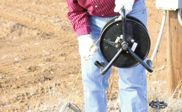 Field Staff Supervisor Keith Whitworth uses an E-Line to make a water level measurement in an observation well. (photo courtesy of HPWD)
