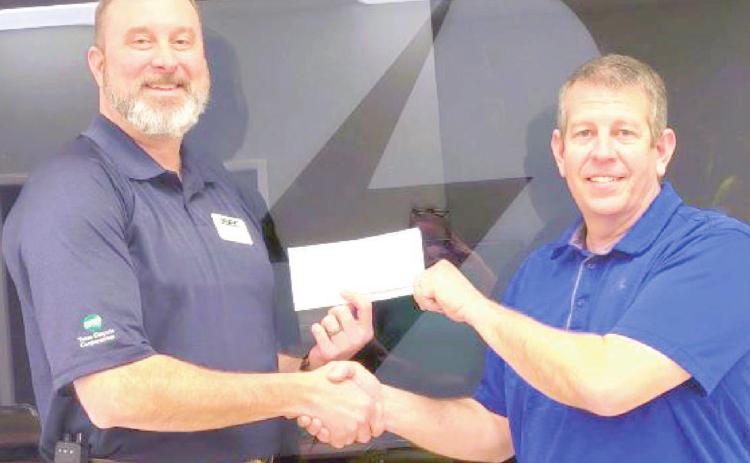 Deaf Smith ED Tim Burkhalter, president and general manager presented a donation to Chris Woodard, Hereford Volunteer Fire Department treasurer.