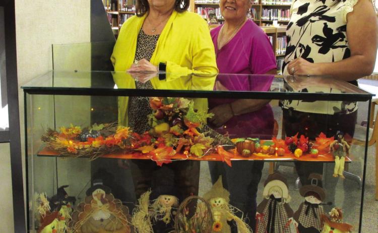 A Thanksgiving-themed exhibit serves as the November display at Rhoads Memorial Library, courtesy of Gloria Hernandez of Castro County Cares. She is flanked by library personnel who staged the display: Sulema Oltivero, left, and Rosa Medina, right, who is the library's newest staff member.