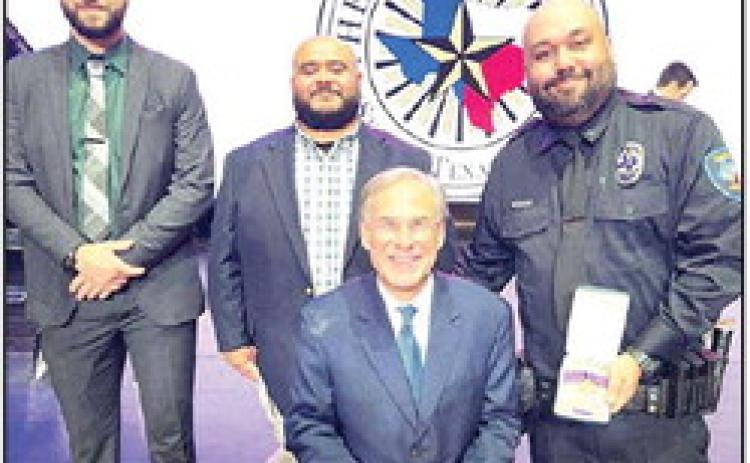DPD Officer Nicolas Montelongo, accompanied by DPH Police Chief Tony Ramirez and Lt. Ben Elmore, received the Star of Texas Award from Gov. Greg Abbott.