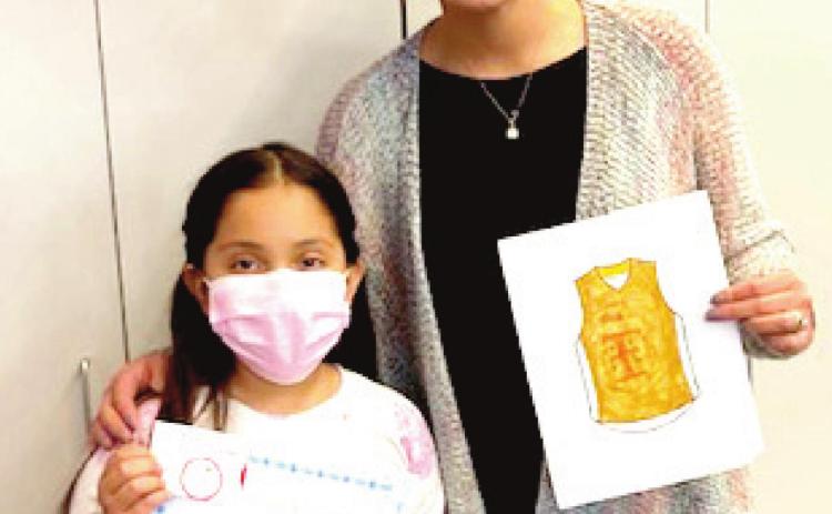 RES student Daisy Gonzales, winner of the girls coloring contest and Principal Maritssa Flores