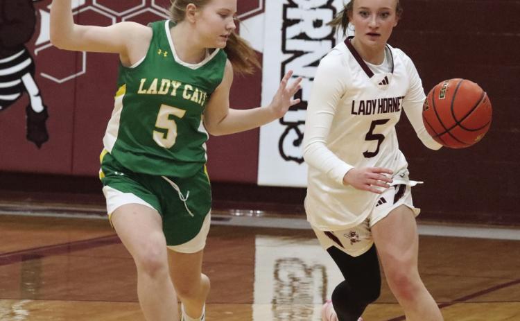 Sage Gore brings the ball down the court