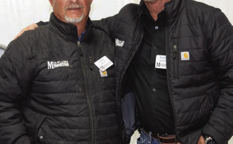 Mid-Plains General Manager Dusty George (right) congratulates Chris Wright on 34 years of service with Mid-Plains Communications