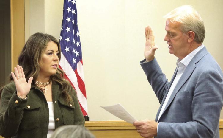 Katie Sims receives her Oath of Office from County Judge Michael Clawson
