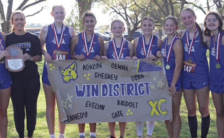 Bridget Osterkamp, Coach Whitney Bryan, Kennedy Wilhelm, Cate Moore, Adalyn O’Connor, Chesney Farris, Gemma Pohlmeier, Cora Rogers and Evelyn Farris pictured with the district championship trophy