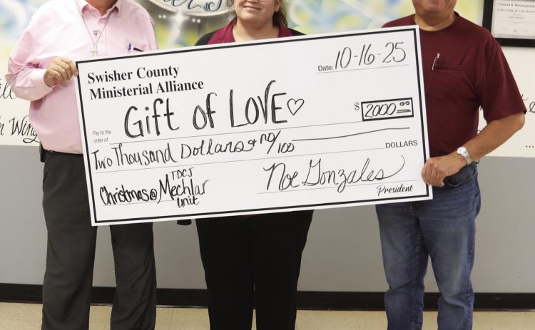 Swisher County Ministerial Alliance presented the TDCJ Mechlar Unit with a Gift of Love to help with Christmas gifts for the residents. Bryan Adams and Monica Brown from the Mechlar Unit accept the donation from Noe Gonzales from the Swisher County Ministerial Alliance.