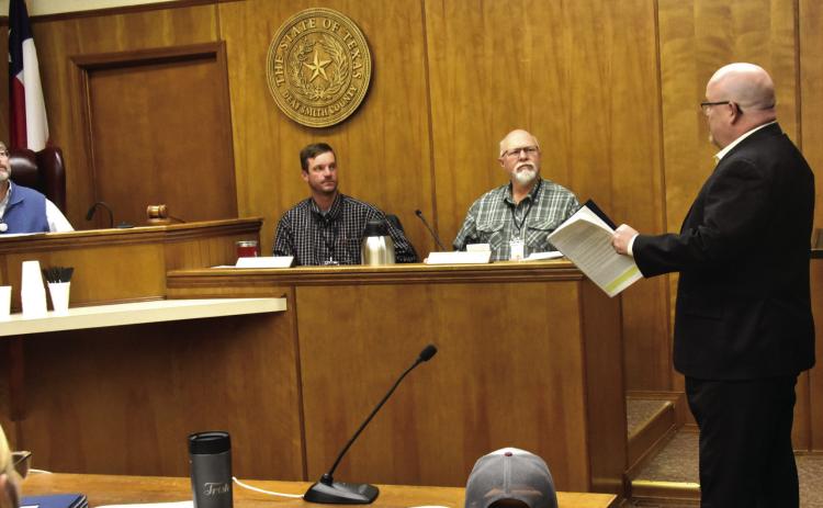 WHAT DID HE SAY?--County Commissioners Kevin Brown and Chris Matthews joined their fellow commissioners in attempting to keep up with what ultra-fast-talking John Merris, right, of Doshier, Pickens and Francis, LLC Certified Public Accountants was saying as he delivered a highly positive presentation of the county’s independent auditor’s report for the year ending September 30, 2025. Fortunately for the commissioners, they had a handout of the report so they could follow along. (Photo by Jim Steiert)