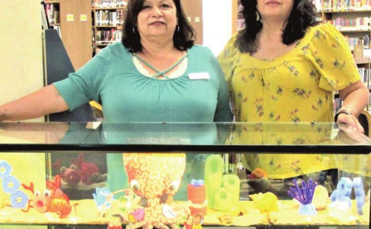 Rhoads Memorial Library staff members Sulema Oltivero, left, and Patty Padilla are Displayers of the Month for June and July.