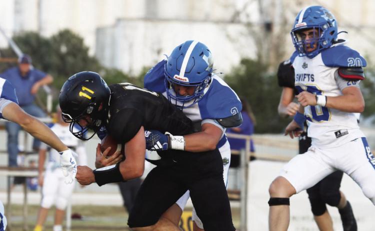 The Nazareth Swifts (above, against Happy in week one) lost to Borden County Friday 50-0. Pictured above are Rhett Ethridge (5), Copper Farris (2), Cole Braker (20) and Lin - coln Pohlmeier (1).