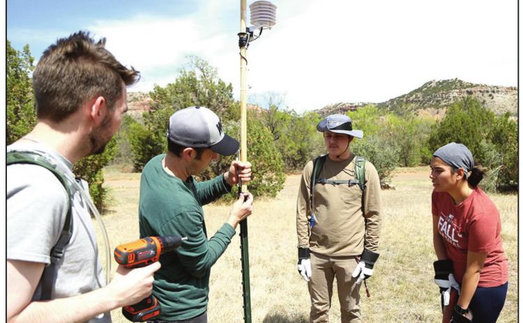 WTAMU Dr. Erik Crosman, second from left, and students Glen Schneider, Cristian Campos and Monica Ghosh install weather sensors in Palo Duro Canyon State Park in 2021. The sensors are being used now for a second year in a study of extreme temperatures on the canyon floor. (photo courtesy of WTAMU)