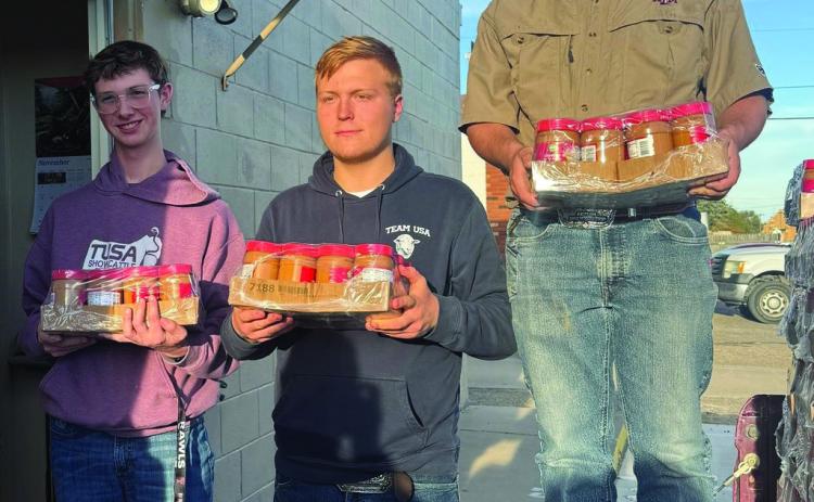 Deaf Smith County 4-H members (from left) Sam Detten, Josef Grotegut and Johan Grotegut chipped in last week to help deliver staples to the Hereford Food Pantry. (Courtesy photo)