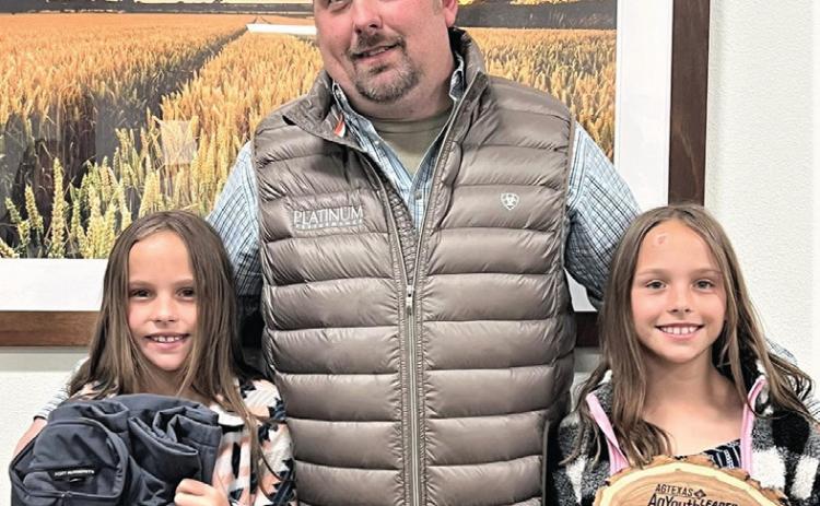 Nazareth Ag teacher and FFA Advisor Austin Heck, shown with daughters Izzy and Gabby, received the AgTexas Ag Youth Leader of Year award. Heck is one of three nominees to be awarded the recognition in Texas this year. Heck has led students to multiple state wins in ag contests and state single teacher chapter awards as well having students go on to universities to compete nationally in ag competitions.