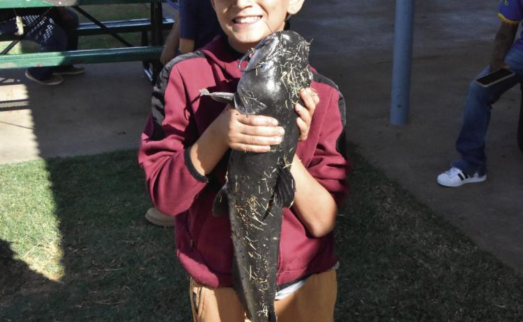NOW THAT’S A CATFISH!—Zayden Tijerina, 10, caught this 26-3/8-inch catfish that took big fish honors at the September 19 Texas Junior Anglers event. (Photo by Jim Steiert)