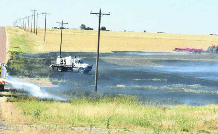 TAKING FIRE PRECAUTION--Well aware of the huge fuel load present going into fall and leading on to the winter and spring fire season, Deaf Smith County commissioners approved providing fire breaks to private landowners at their October 14 session. Fire breaks can buy precious time for fire crews to arrive. Even with the aid of helpful neighbors, wildfires spread fast and minutes count. (Photo by Jim Steiert)