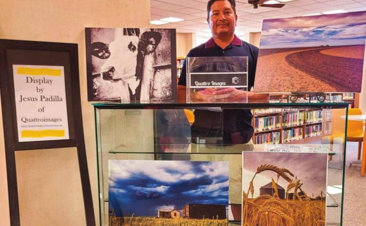 Jesus Padilla of Dimmitt is shown with his photos made in Castro County." Padilla's Display of the Month will be at the library through the end of September.
