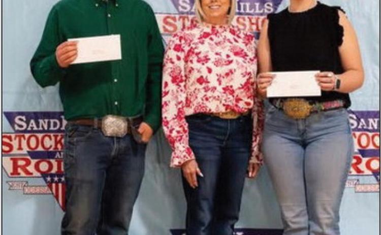 SANDHILLS SCHOLAR--Josef Grotegut, left, a Hereford High School senior, was awarded a scholarship from the SandHills Stock Show during the Jan 1011 weekend. It was the last Odessa show for the veteran young lamb and breeding sheep showman, who expressed his thanks to the SandHills Stock Show and Rodeo for investing in his future.