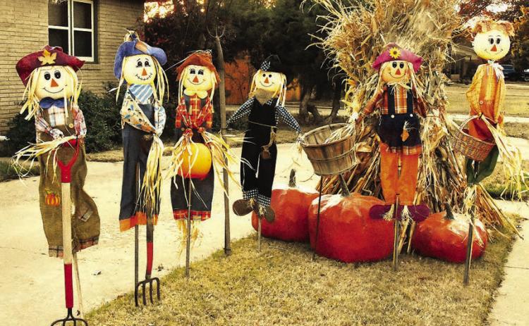 BUSHELS OF BLESSINGS-- Thanksgiving-styled yard decorations bring a harvest theme to a local neighborhood, bringing to mind just some of the things we have to be thankful for in this season of remembering and feasting. The frost has not been on the pumpkin all that much this fall, but a few snappy mornings and crisp afternoons have brought to mind past times of gathering fodder in the shock. (Photos by Jim Steiert)