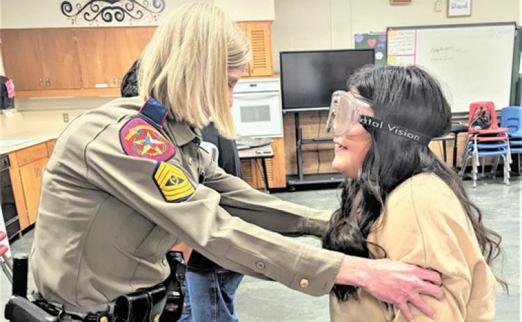Family Consumer Science/Health classes at Dimmitt Middle School experienced DWI goggles while trying to walk a straight line, Aliyah Castillo needed a little help from DPS Sergeant Barkley.