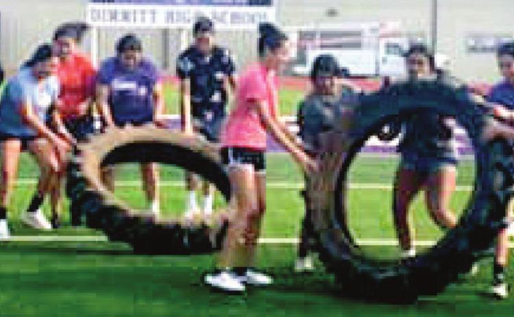 Heavy tractor tires make for an interesting workout tool for the Dimmitt Bobbies.