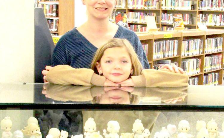 Displayer of the Month is a Precious Moments figurine display belonging to Rhonda George of Hart, represented by daughter, Kellie O’Connor, and granddaughter, Eleanor.