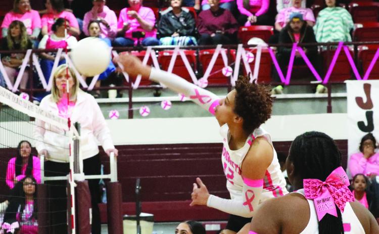 Michelle Mott hits the ball over the net