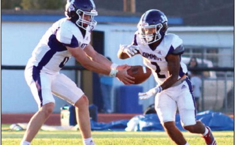 The Bobcats quarterback hands the ball off as Olton defense presses down. (Dimmitt Sports Media)